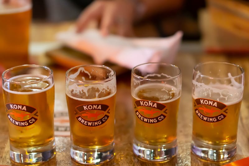 Kailua-Kona, Hawaii, October 2018. Flight of four beers sitting on a table at Kona Brewing Company.